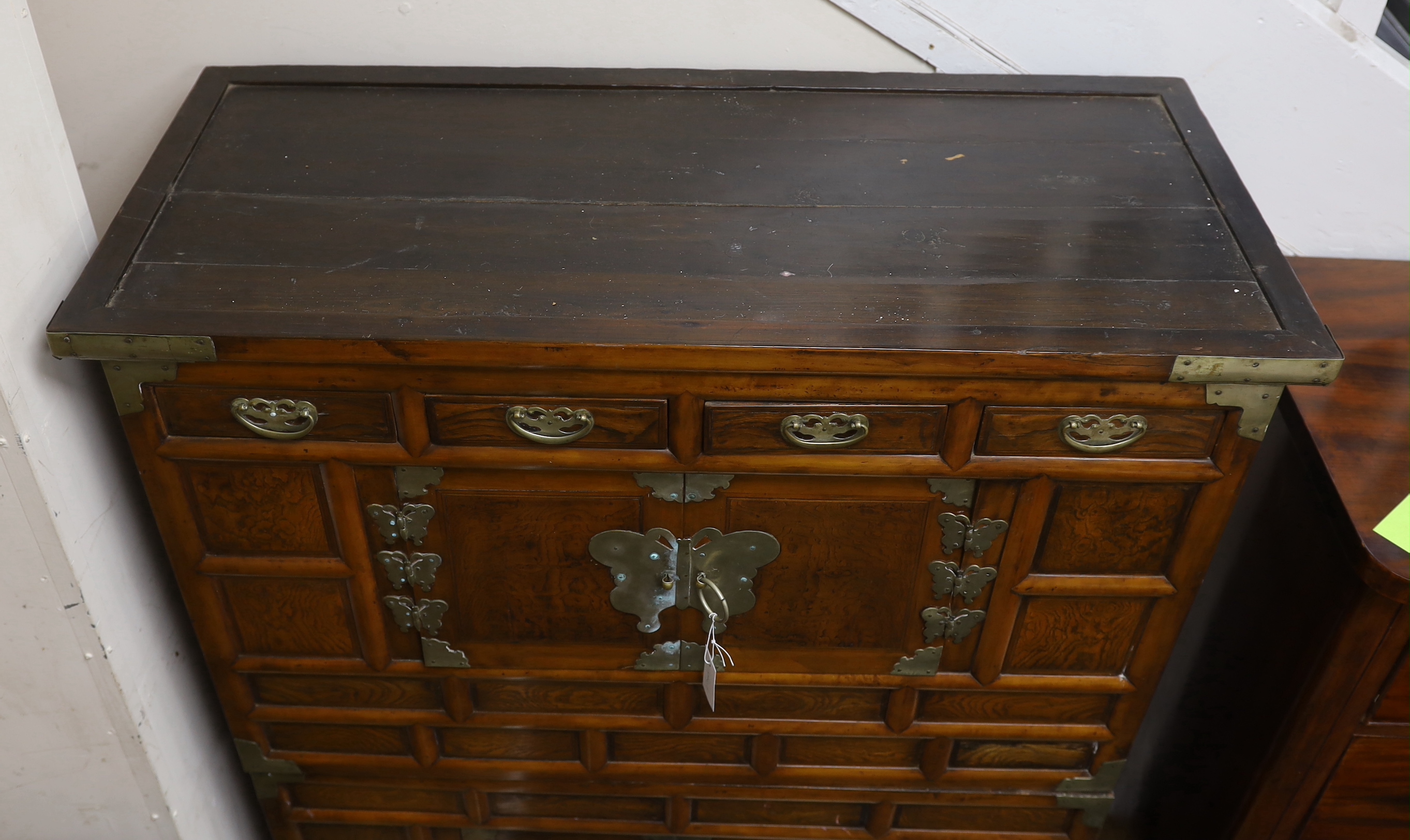 A Korean gilt metal mounted elm two part side cabinet, width 108cm, depth 46cm, height 149cm